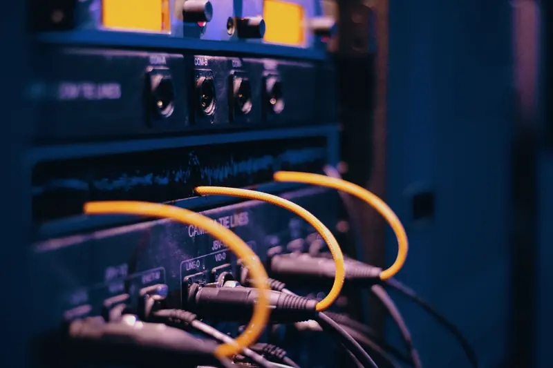 Cables plugged into rack-mounted equipment.
