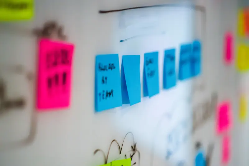 Coloured sticky notes grouped on a whiteboard for planning.
