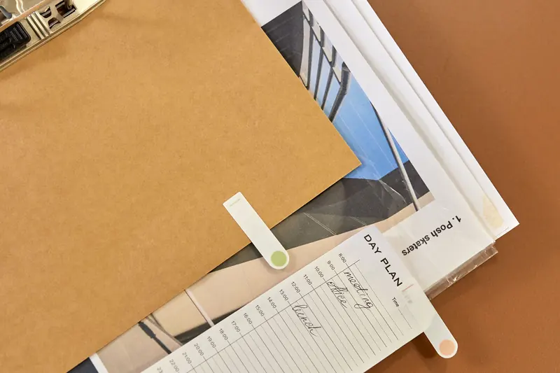 A day planner and paper documents arranged beneath a folder.