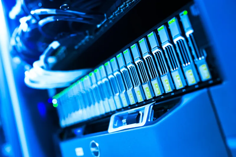 A close-up of removable drives and status lights in server hardware.